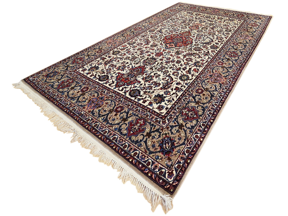 Esfahan perizisch rug with cream field, dark blue border, red medallion, and short fringe
