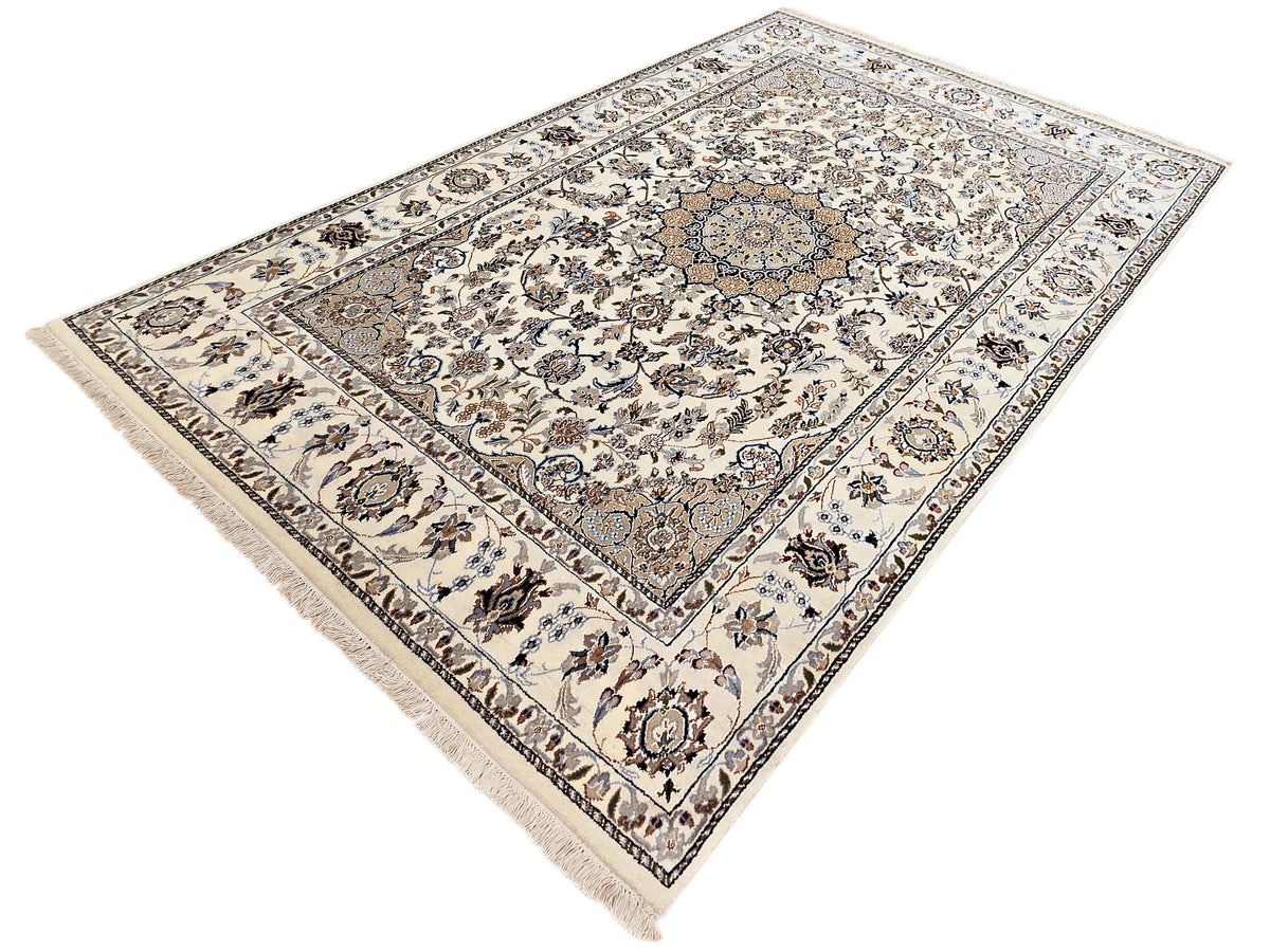Nain rug with ivory floral medallion design, blue and brown details, short fringed edge