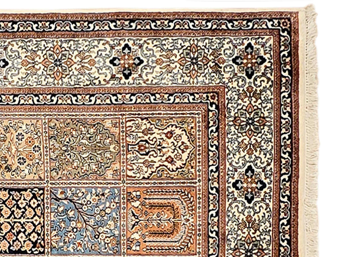 Close-up of rug border with dark outlines, cream background, and fringed corner