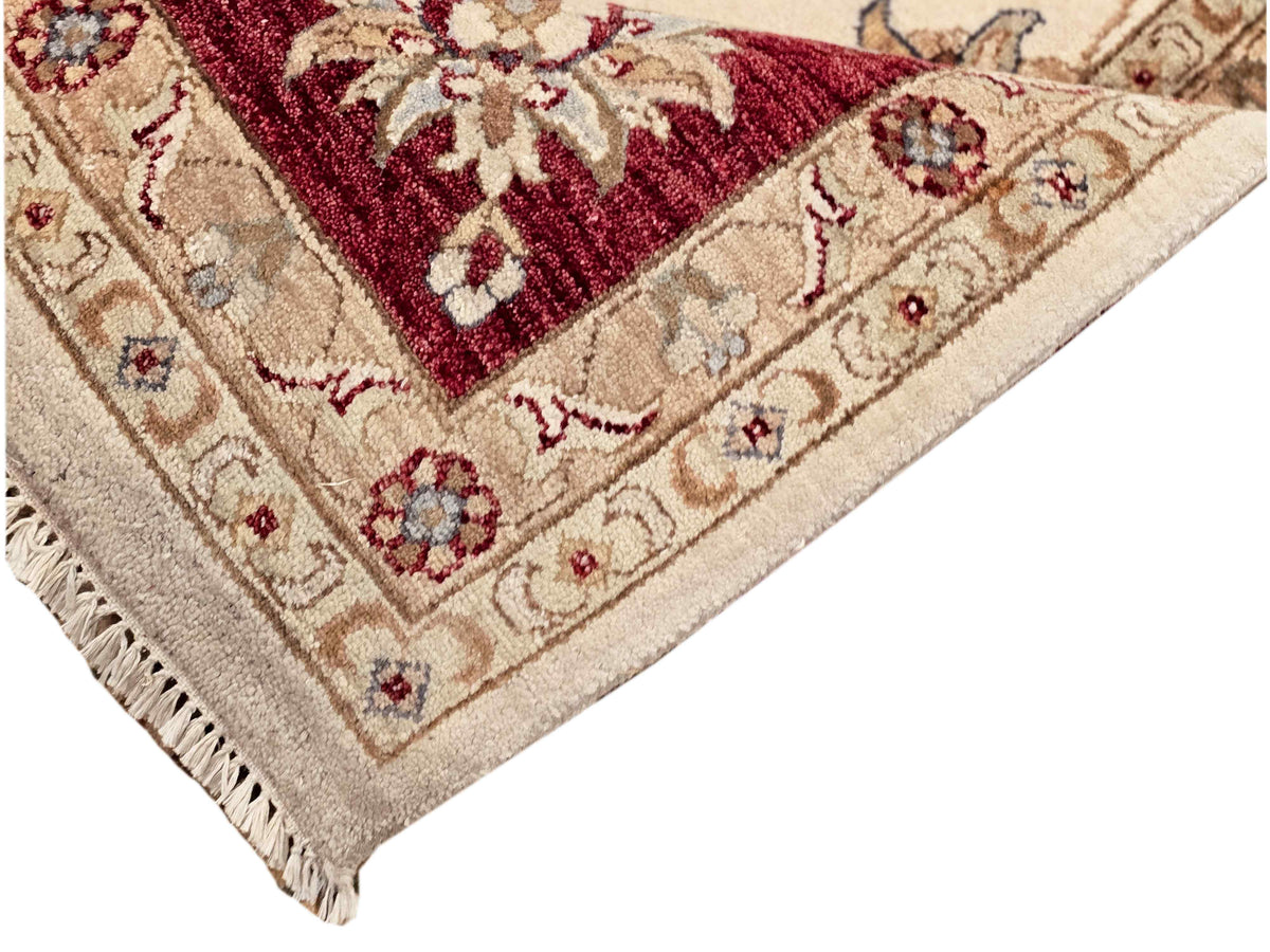 Ziegler rug with cream field, burgundy border, ornate medallion pattern, fringed edge