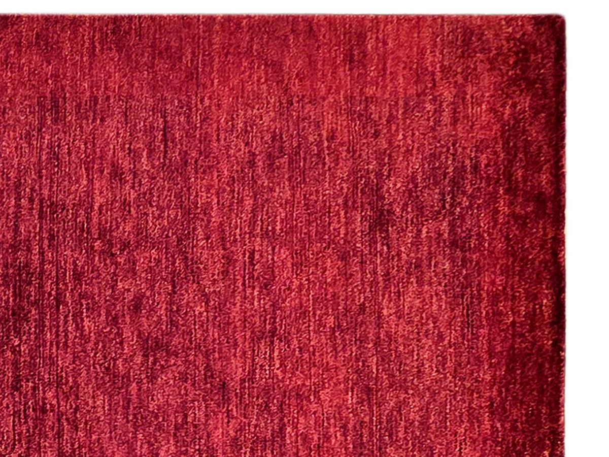 Red rug corner with dense vertical textured pile