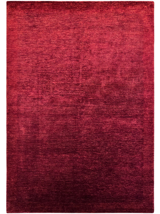Red rectangular rug with abstract mottled pattern