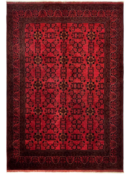 Square red rug with central medallion, dark detailing, and decorative border pattern.