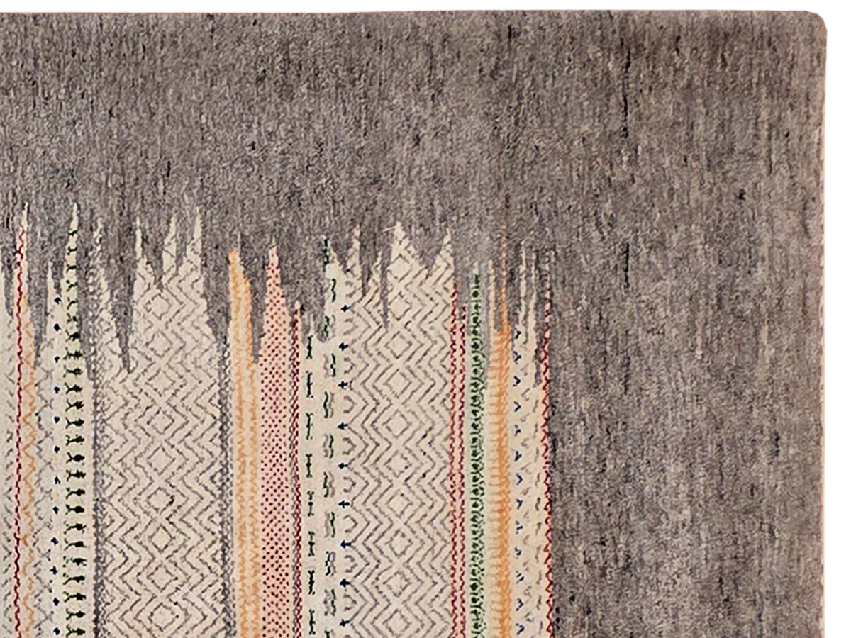 Grey rug close-up with vertical geometric pattern and multicolor accents