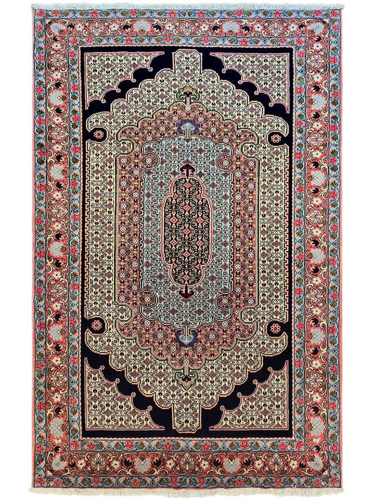 Vertical ornate area rug with floral motifs in red, blue, and cream; fringed look.