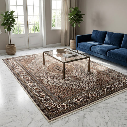 Large patterned area rug in brown, cream, and dark blue with decorative border, fringed.