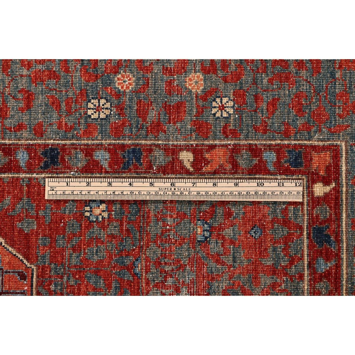 Mamluk rug close-up: red and blue motifs with patterned border and measuring tape