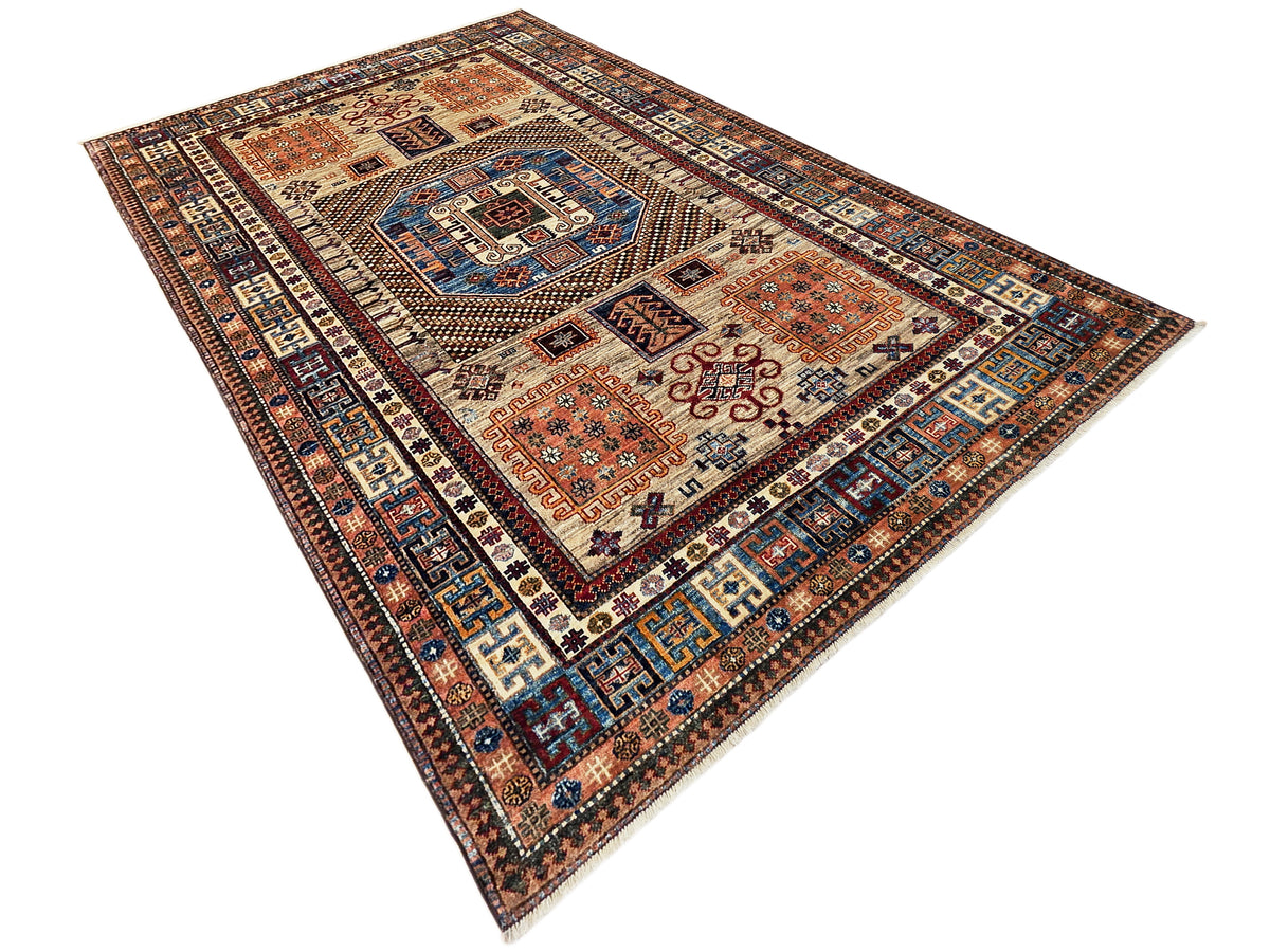 Kazak-style rug corner view with central medallion and navy-blue geometric border, multicolor