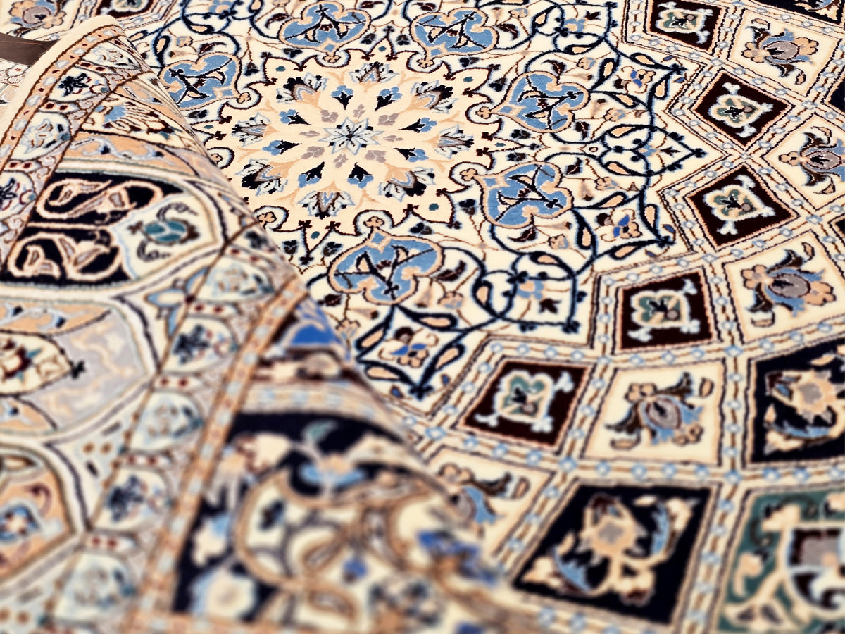 Beige and blue rug surface with intricate geometric and floral tile patterns.