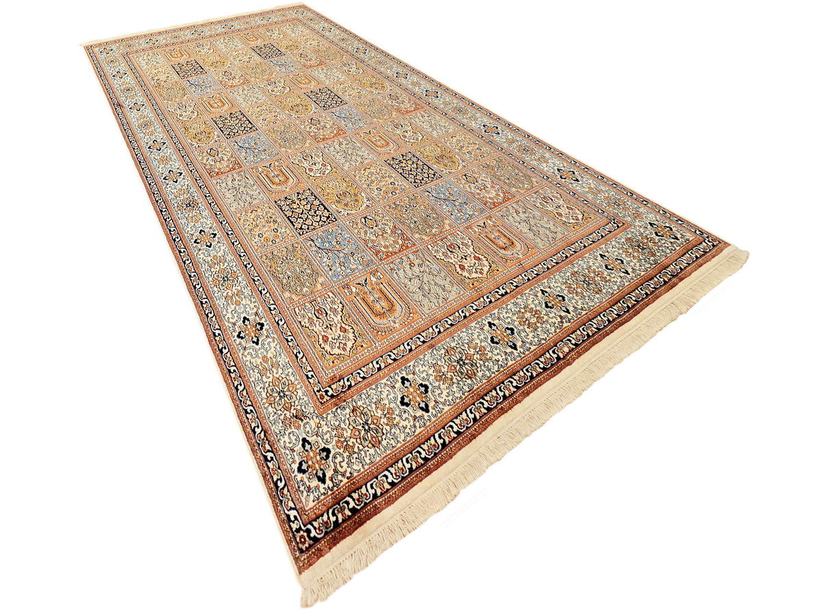 Overhead view of a multicolor patterned rug with ornate border and fringe trim