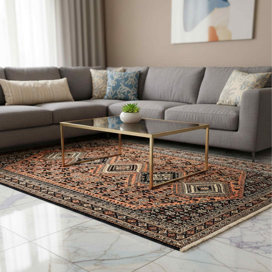 Orange and dark navy geometric area rug with ornate border, centered in living room