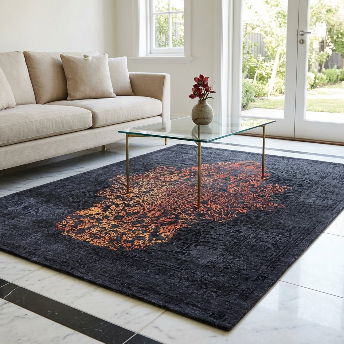 Dark navy rug with orange-red abstract center medallion, in living room setting